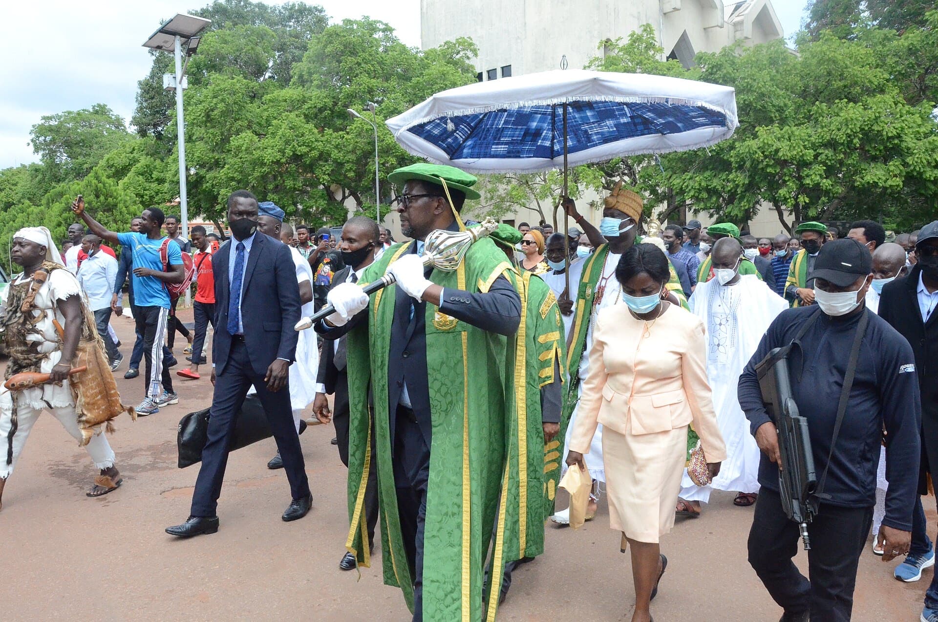 The University of Nigeria’s convocation procession, led by the mace bearer in green and gold regalia